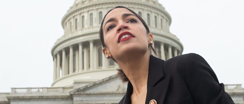 US-Representative-Alexandria-Ocasio-Cortez-Democrat-of-New-York-leaves-a-photo-opportunity-with-the-female-Democratic-members-of-the-116th-US-House-of-Representatives-outside-the-